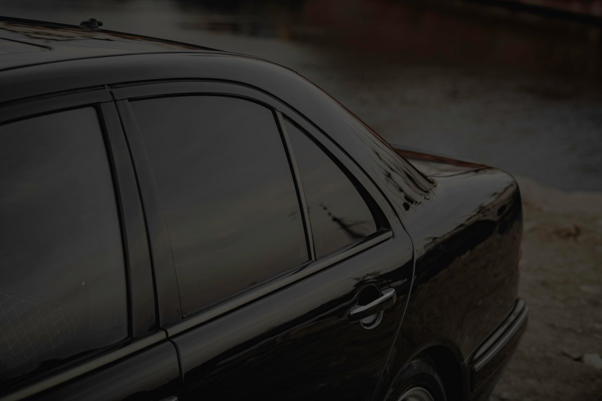 Close-up of dark ceramic window tint film on a car